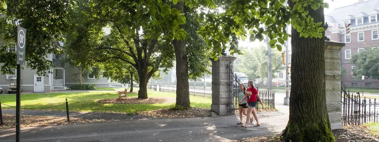 Two students walking on to campus.